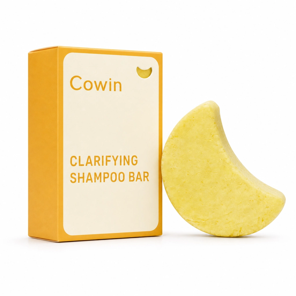 Cowin yellow crescent-shaped shampoo bar beside a white and yellow carton