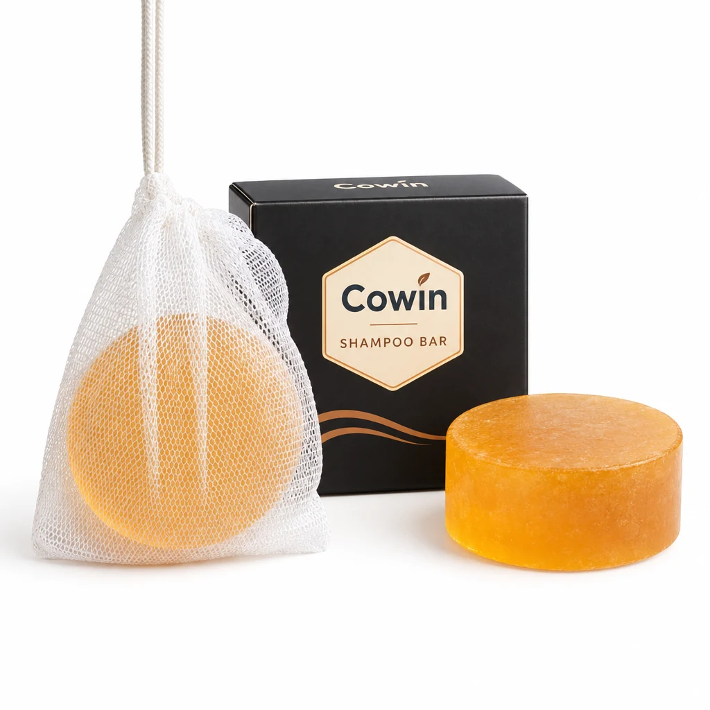 Cowin golden round shampoo bar beside a mesh pouch and black carton
